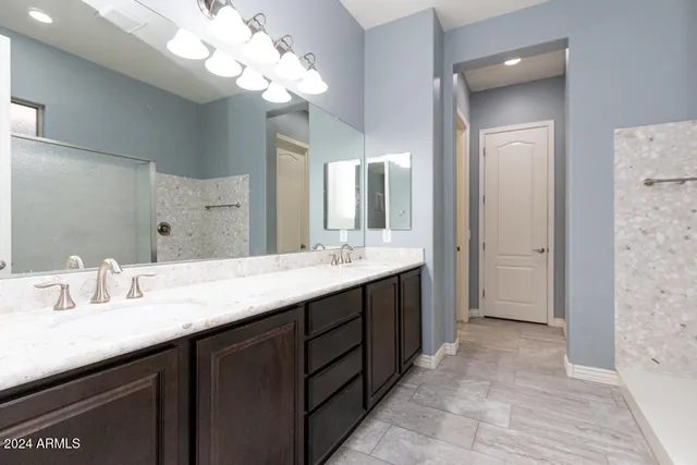 a bathroom with a double vanity sink mirror and double
