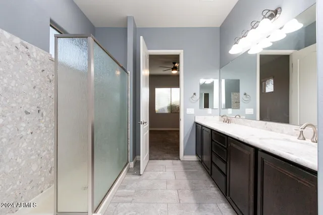 a large bathroom with a double vanity sink and a mirror