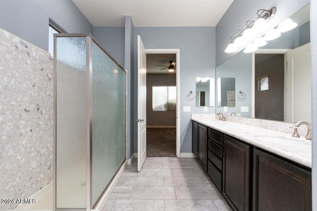 Undisclosed Address Gilbert, AZ 85298 - Photo 18 of 36 a large bathroom with a double vanity sink and a mirror