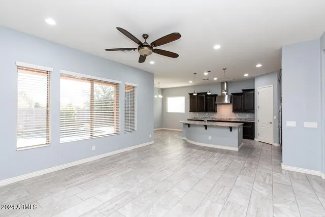 a view of a living room kitchen and windows