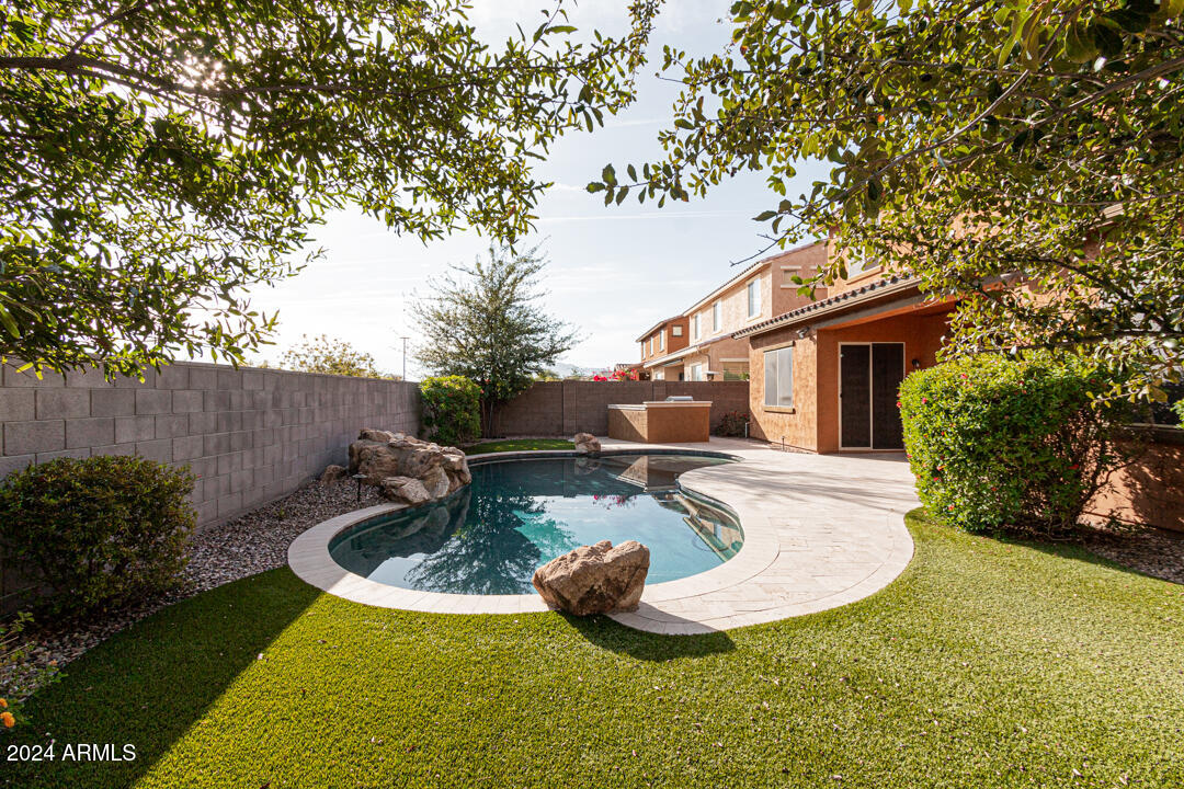 Undisclosed Address Gilbert, AZ 85298 - Photo 2 of 36 a view of a house with backyard swimming pool and sitting area