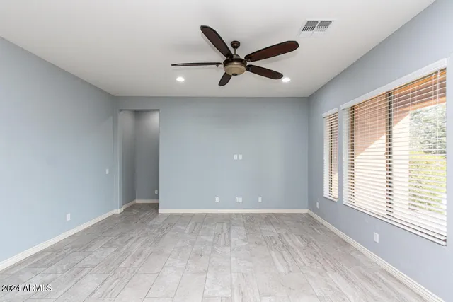 a view of a livingroom with a ceiling fan and window