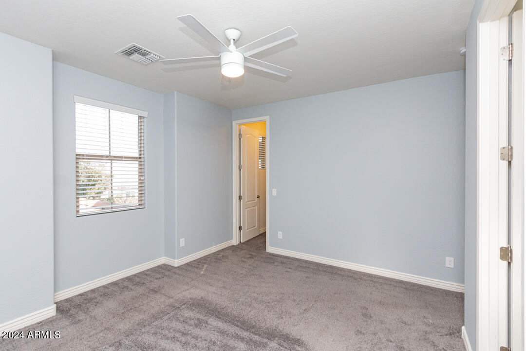 Undisclosed Address Gilbert, AZ 85298 - Photo 25 of 36 an empty room with windows and fan