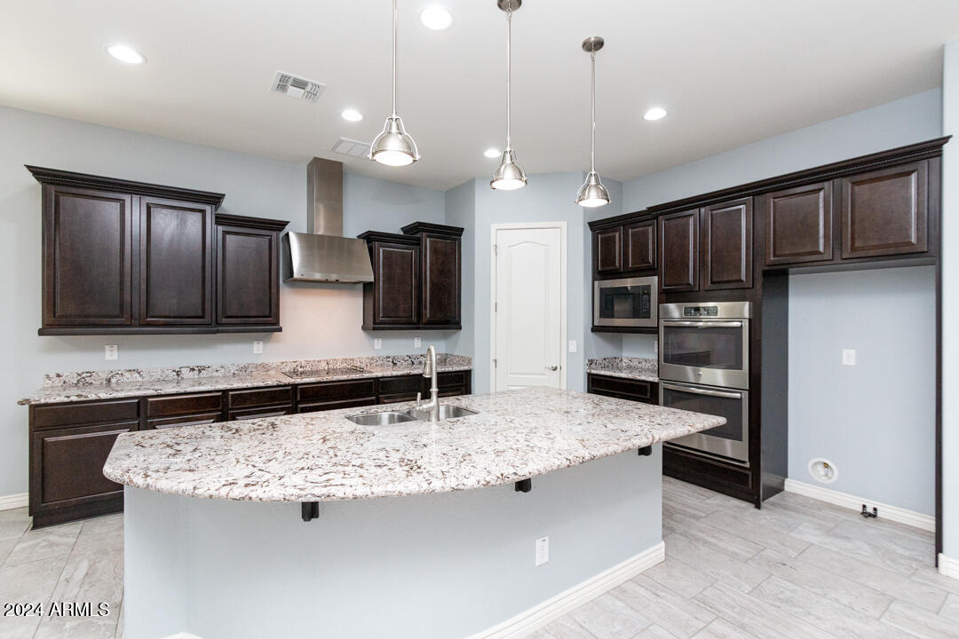 Undisclosed Address Gilbert, AZ 85298 - Photo 10 of 36 a view of kitchen with refrigerator stove microwave and cabinets