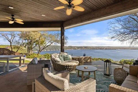 a living room with patio furniture and a floor to ceiling window