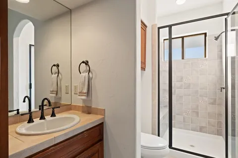 a bedroom with a bed and a large window with the outer view