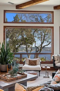 a living room with furniture and a floor to ceiling window