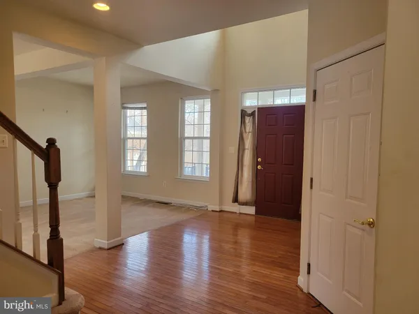 an empty room with wooden floor and a window