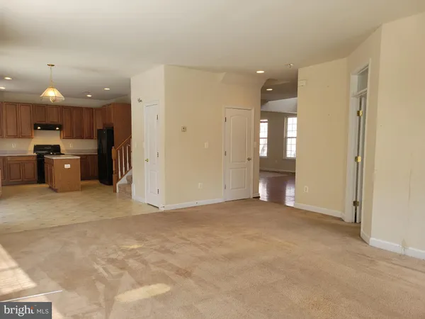 a view of a kitchen with a sink and a refrigerator