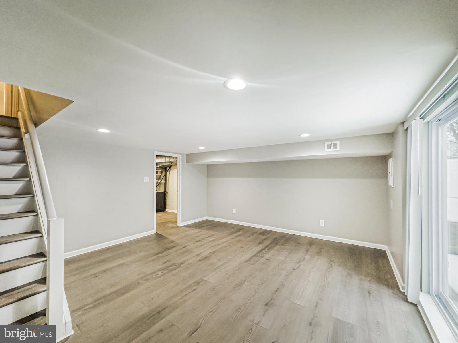 11118 Ridgeway Street Philadelphia, PA 19116 - Photo 32 of 38 wooden floor in an empty room with a window