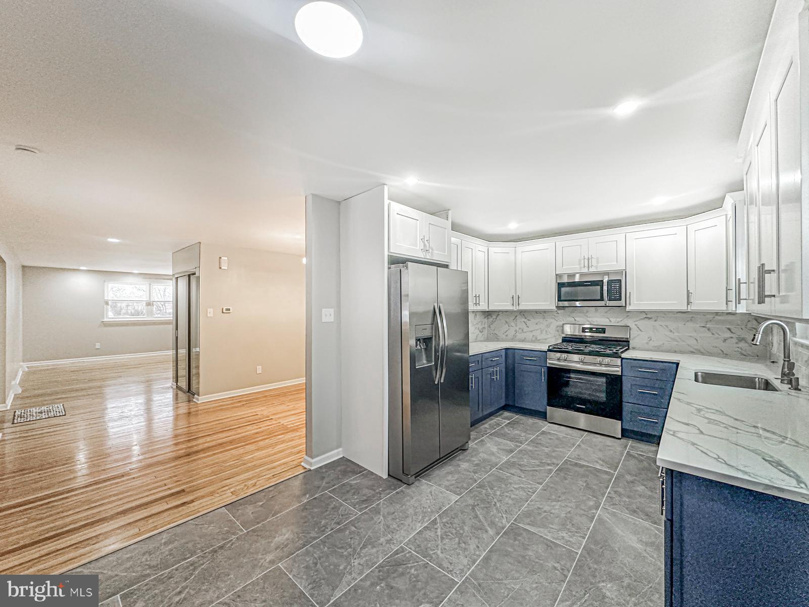 11118 Ridgeway Street Philadelphia, PA 19116 - Photo 8 of 38 a large kitchen with stainless steel appliances kitchen island granite countertop a refrigerator stove and oven