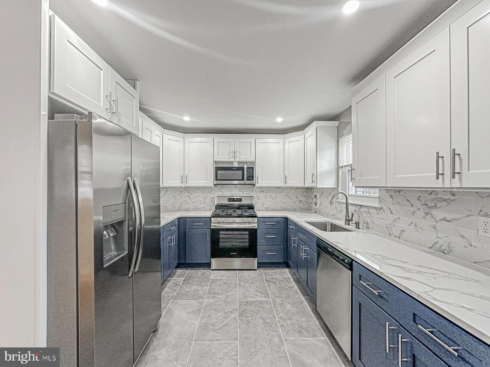 11118 Ridgeway Street Philadelphia, PA 19116 - Photo 9 of 38 a large kitchen with stainless steel appliances granite countertop a sink stove and refrigerator
