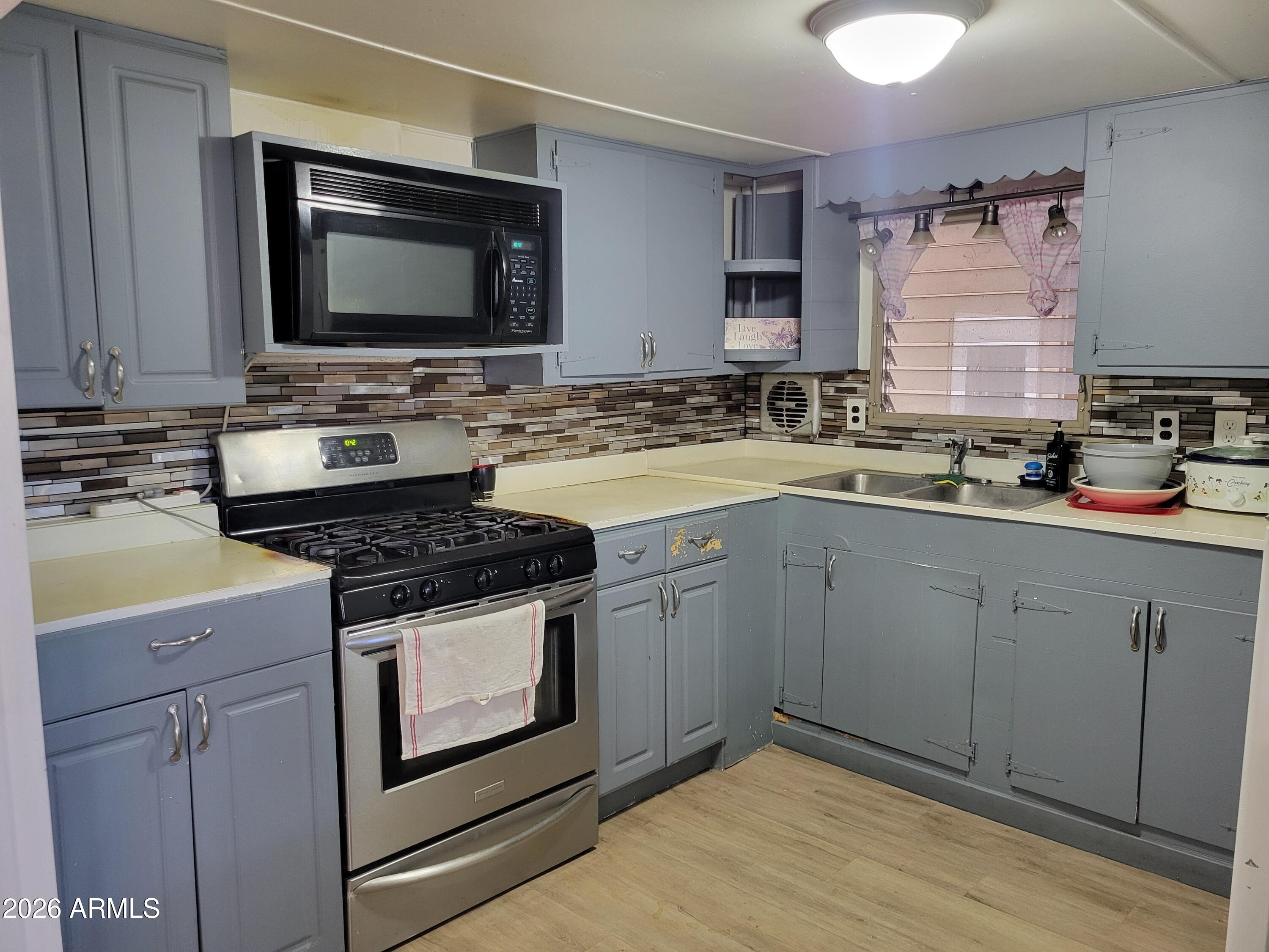 2460 East Main Street, Unit S03 Mesa, AZ 85213 - Photo 1 of 21 a kitchen with a sink stove and microwave