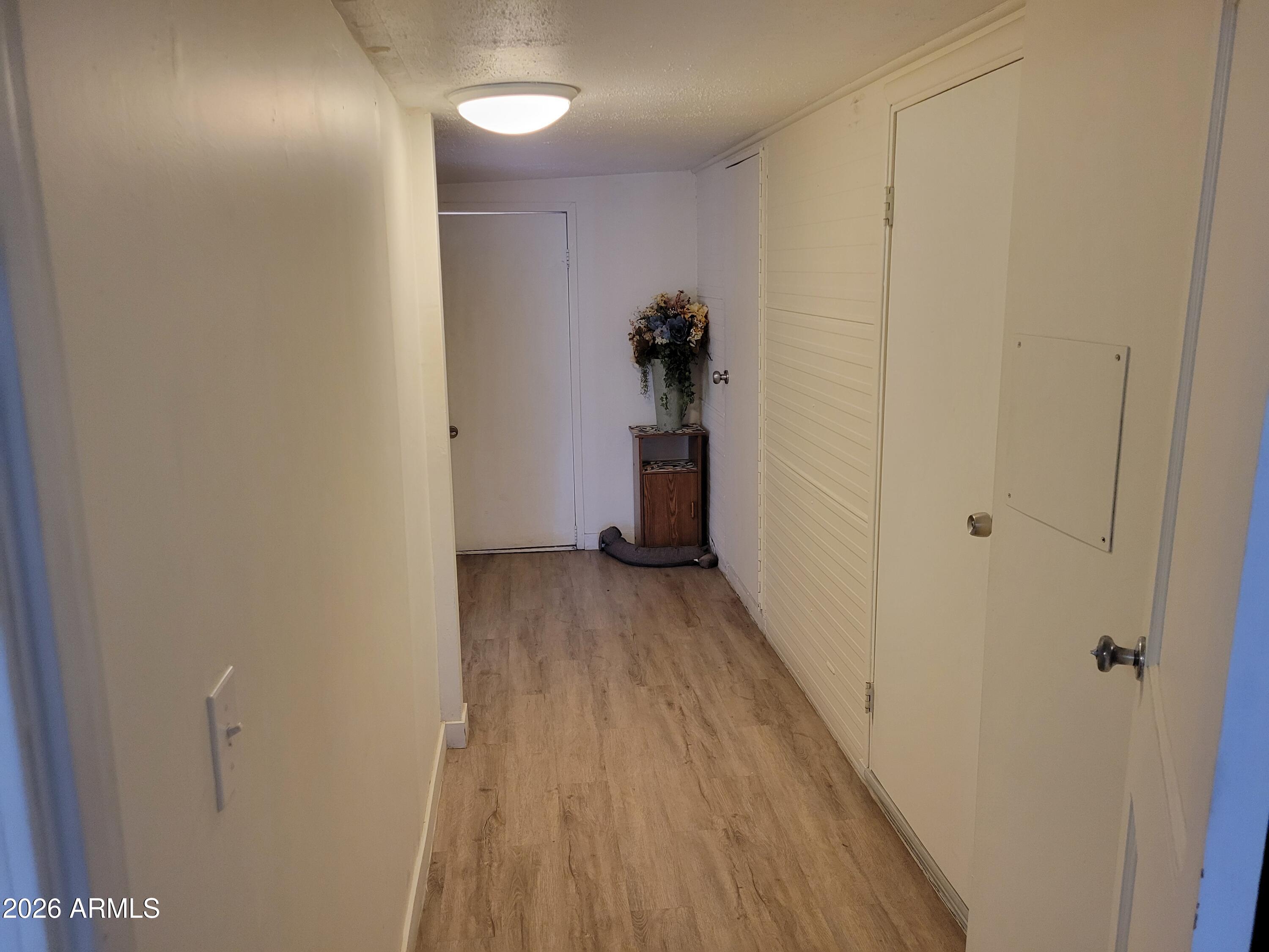2460 East Main Street, Unit S03 Mesa, AZ 85213 - Photo 11 of 21 a view of a hallway with wooden floor and a bathroom