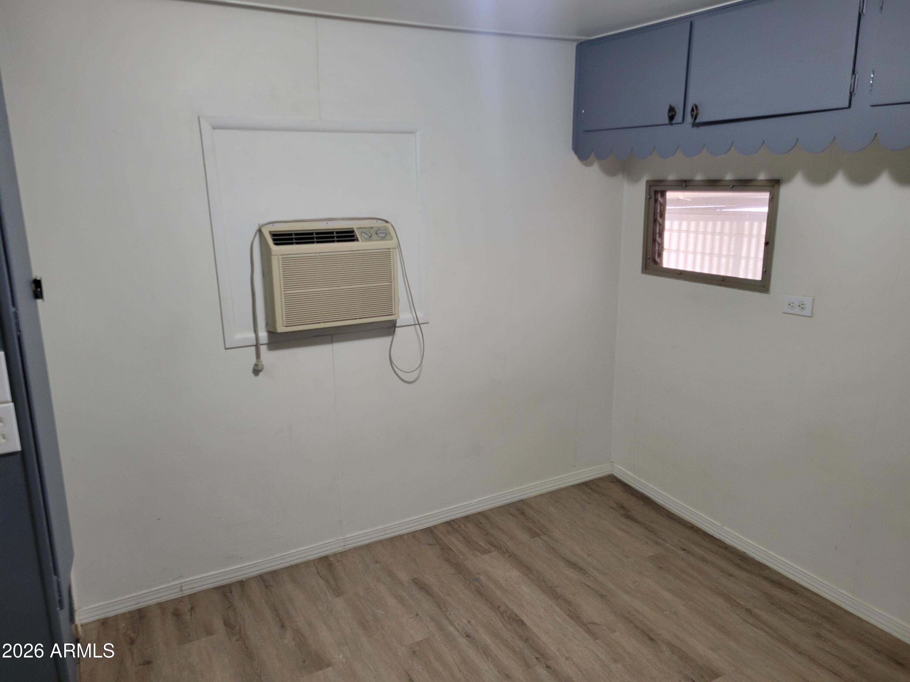 2460 East Main Street, Unit S03 Mesa, AZ 85213 - Photo 13 of 21 a view of a room with wooden floor and cabinets