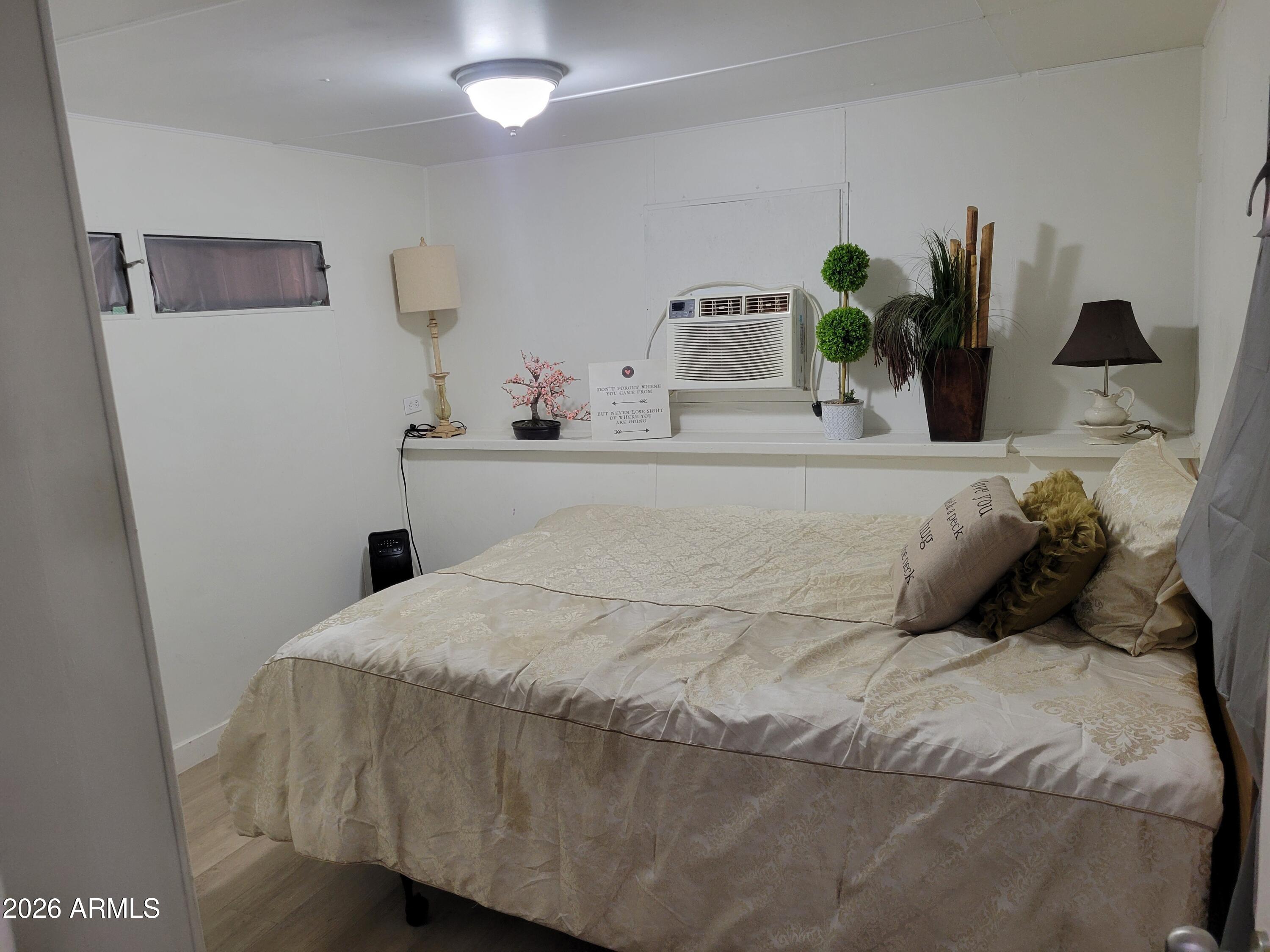 2460 East Main Street, Unit S03 Mesa, AZ 85213 - Photo 6 of 21 a bedroom with a bed and window