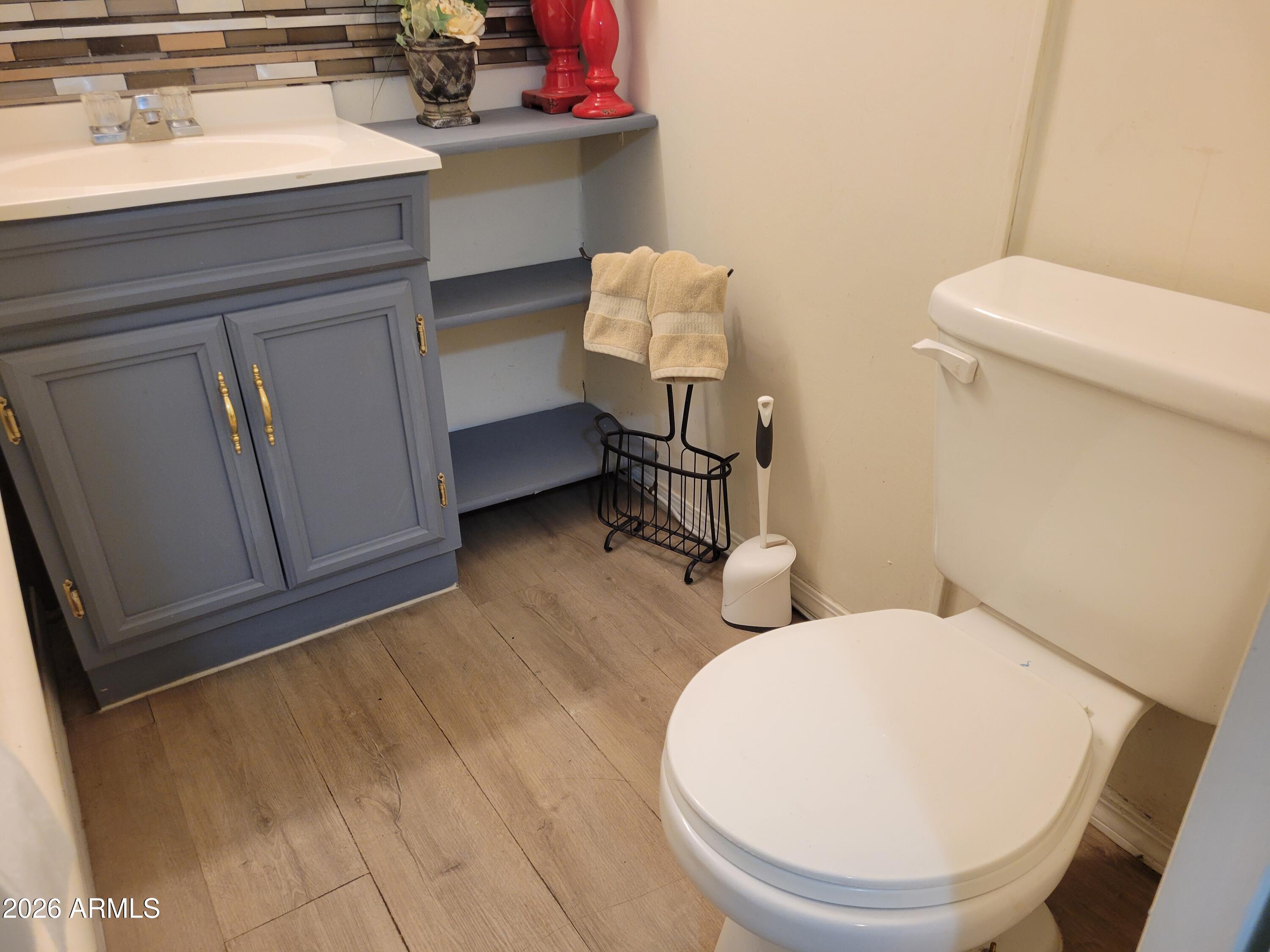 2460 East Main Street, Unit S03 Mesa, AZ 85213 - Photo 9 of 21 a bathroom with a sink toilet and mirror