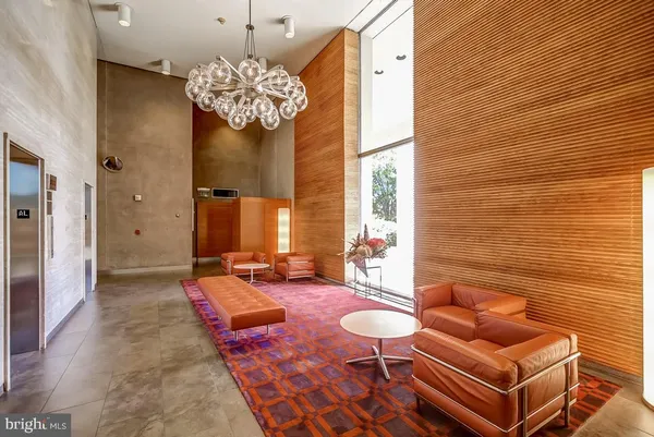 a living room with furniture and a chandelier