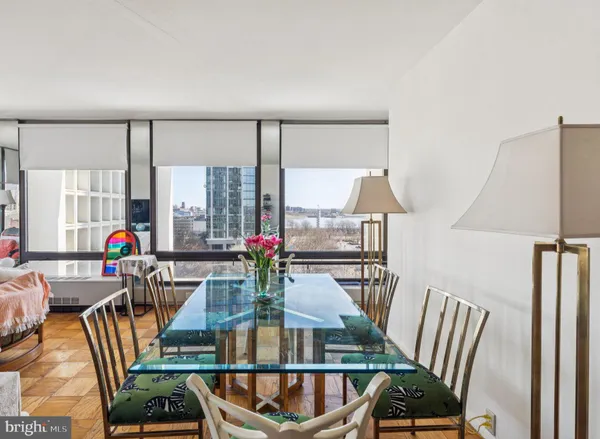 a view of a dining room with furniture a chandelier and wooden floor