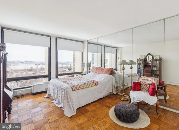 a spacious bedroom with a bed and a large window
