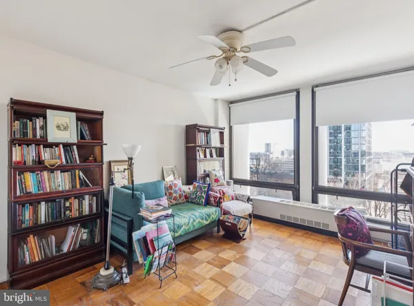 a living room with furniture and a book shelf