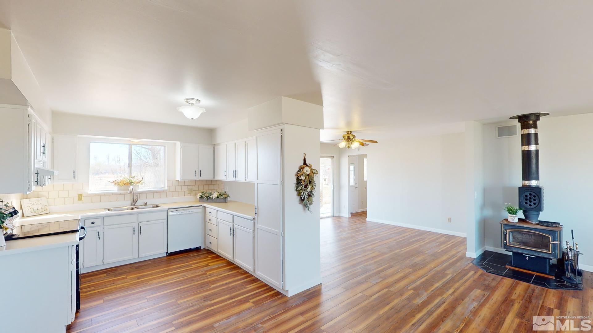 4121 Solias Road Fallon, NV 89406 - Photo 5 of 37 a view of a kitchen cabinets a sink and wooden floor