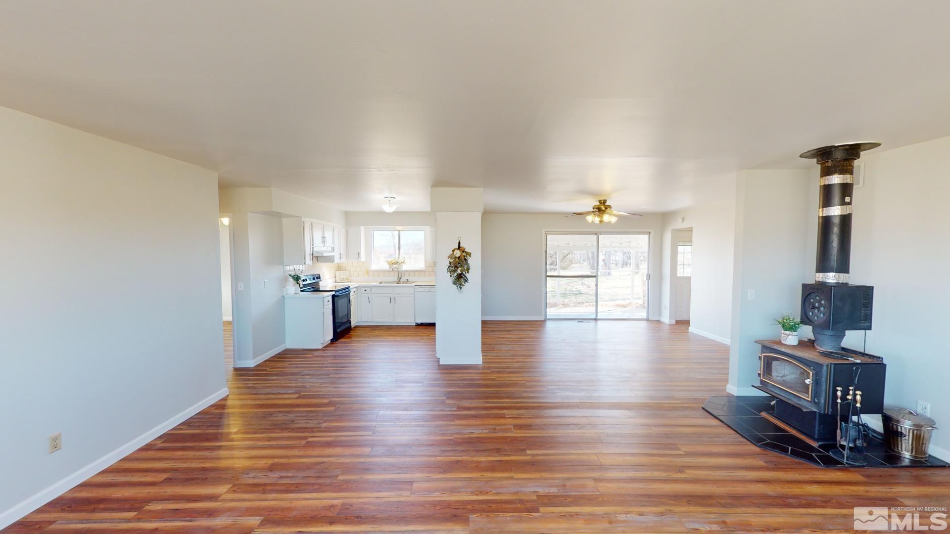 4121 Solias Road Fallon, NV 89406 - Photo 8 of 37 a view of an empty room and kitchen with wooden floor