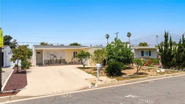 a view of a house with outdoor space and sitting area
