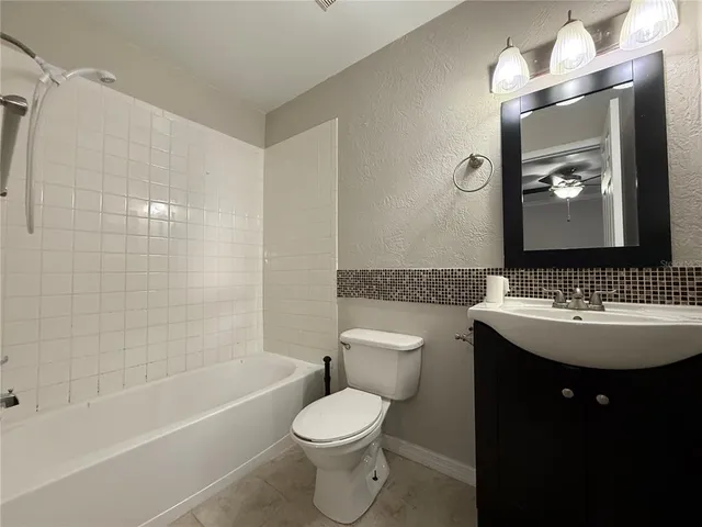 a bathroom with a sink toilet and mirror