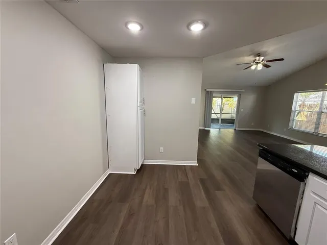 a kitchen with a sink and steel appliances