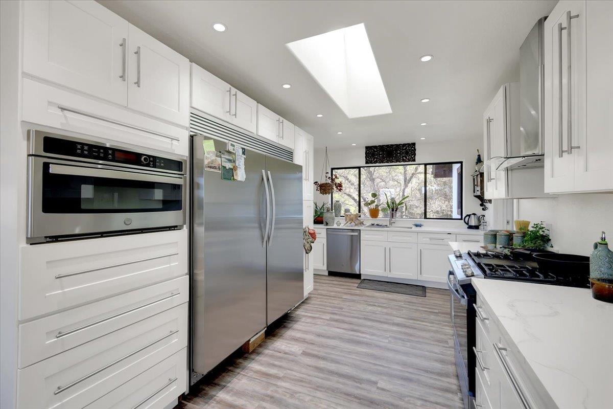 17513 Derby Way Penn Valley, CA 95946 - Photo 14 of 78 a kitchen with stainless steel appliances cabinets and a wooden floor