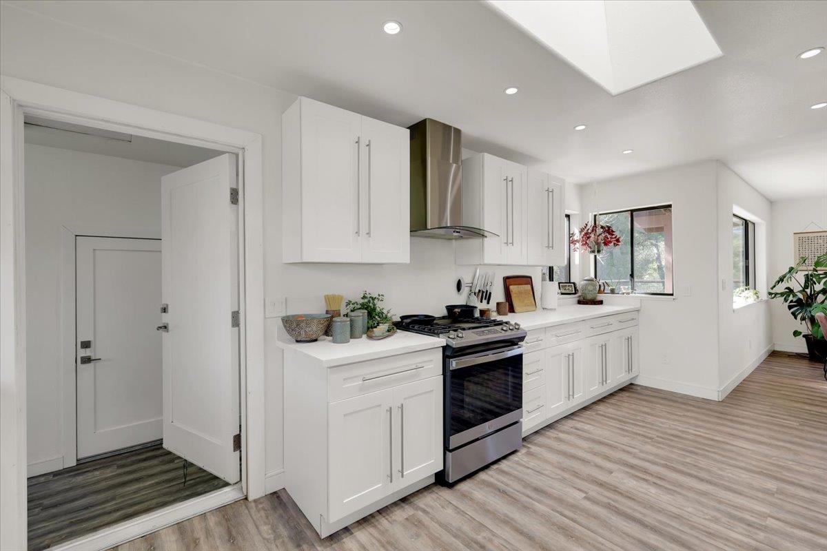 17513 Derby Way Penn Valley, CA 95946 - Photo 17 of 78 a kitchen with stainless steel appliances granite countertop a stove top oven a sink dishwasher and a refrigerator with wooden floor