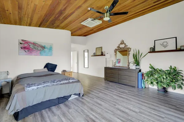 a bedroom with two beds and a large mirror