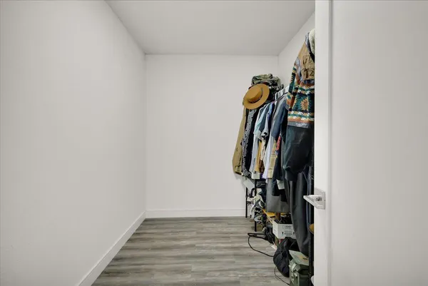 a view of empty room with wooden floor