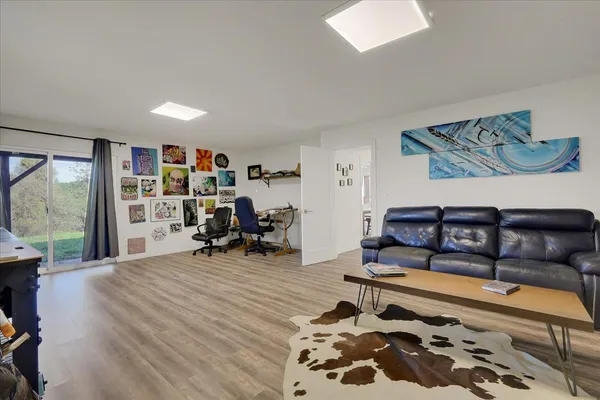 a view of a hallway with wooden cabinets