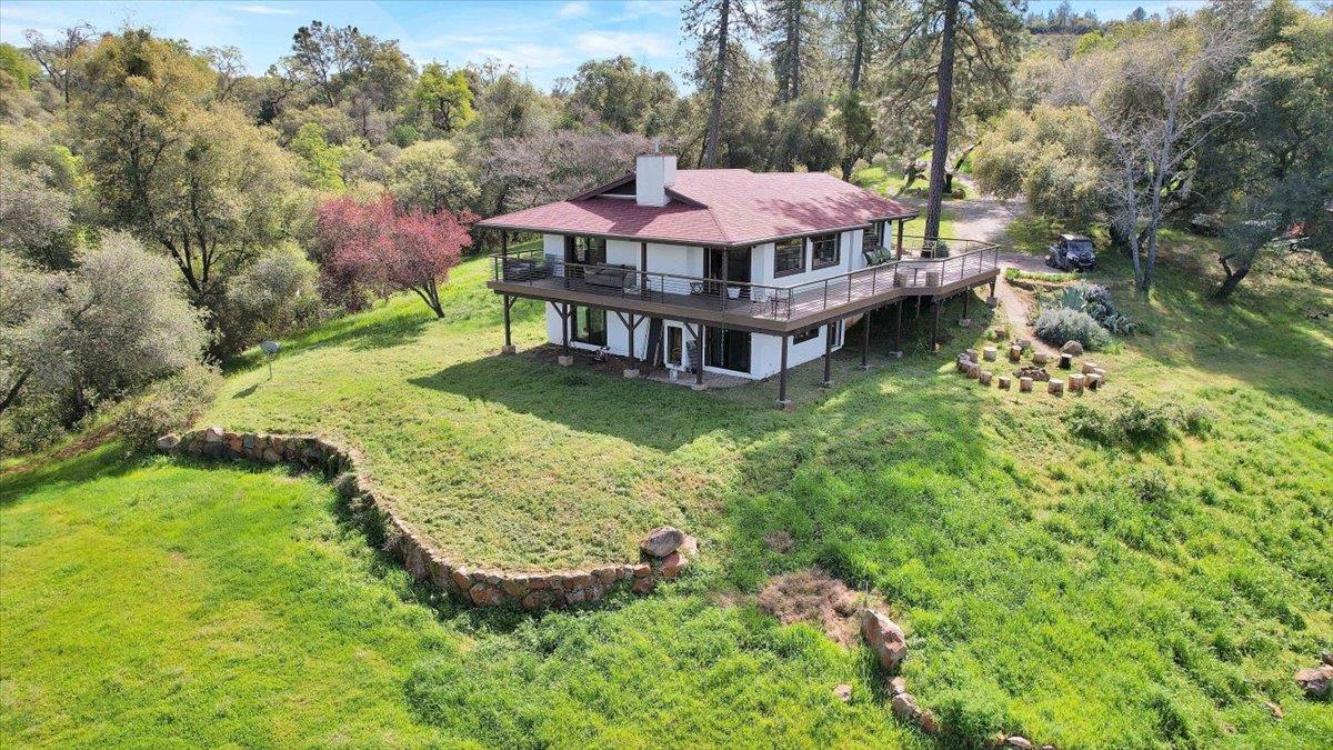 17513 Derby Way Penn Valley, CA 95946 - Photo 3 of 78 a view of a house with a yard table and chairs