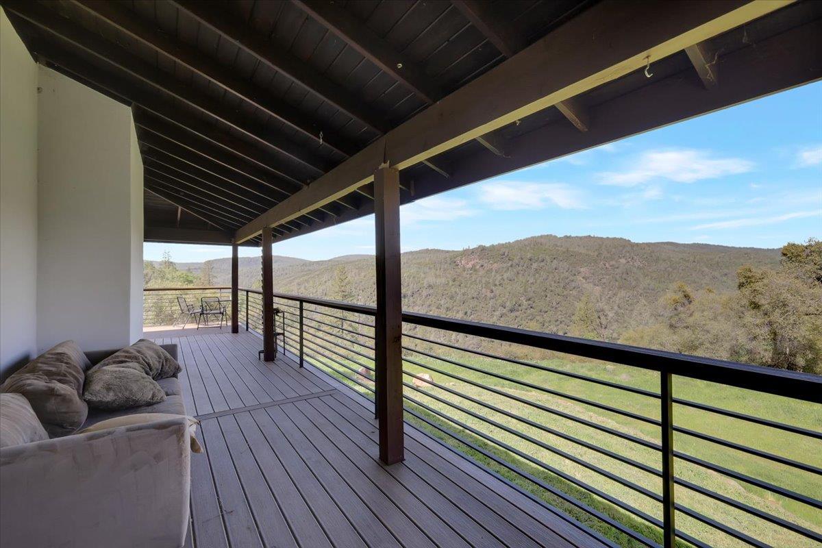 17513 Derby Way Penn Valley, CA 95946 - Photo 43 of 78 a view of a balcony with furniture and wooden floor