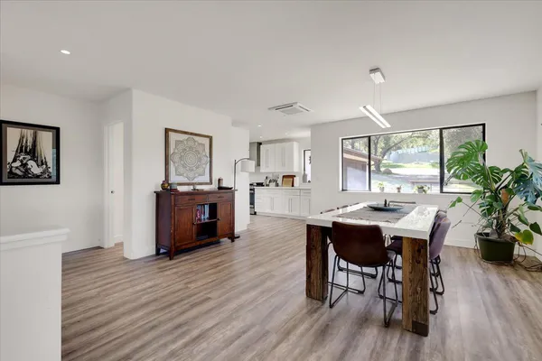 a view of a dining room with furniture and wooden floor