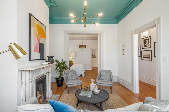a bedroom with a bed and a chandelier
