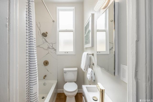 a kitchen with a table chairs sink and cabinets