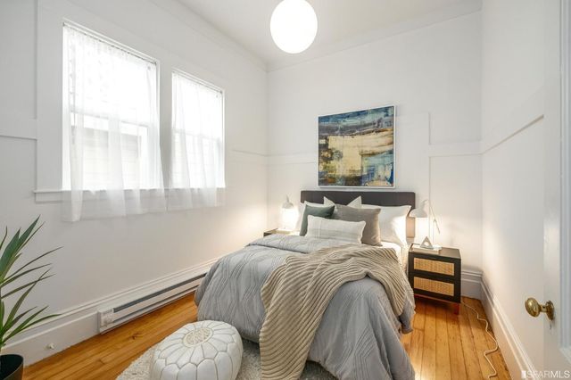 a bedroom with bed and a potted plant