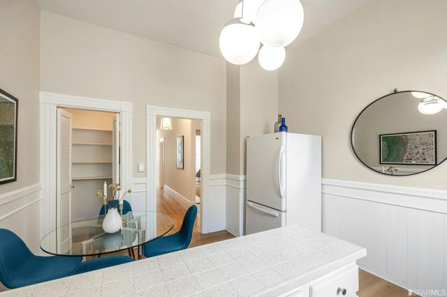 a living room with furniture a fireplace and a chandelier