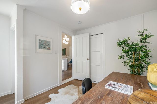 a view of a workspace room with furniture and wooden floor