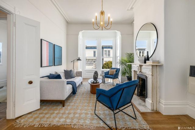 a bedroom with a large bed and a chandelier