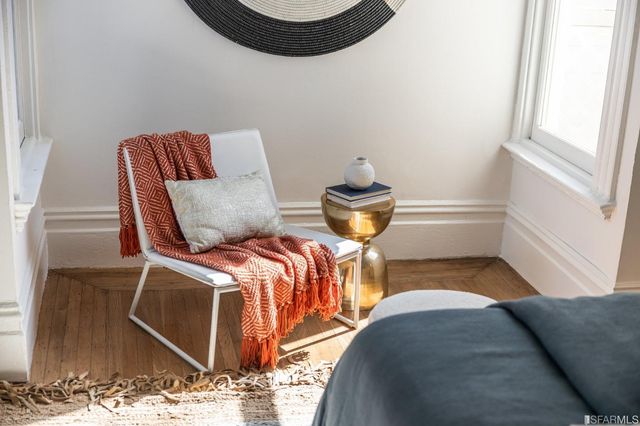 a view of a backyard with chairs and a potted plant