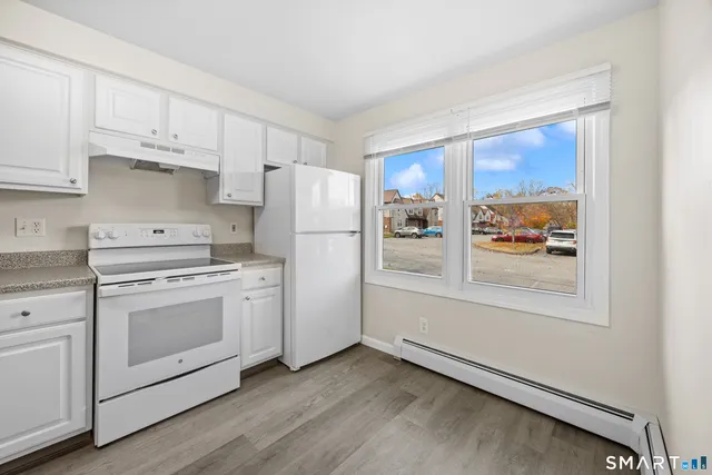 a kitchen with stainless steel appliances a refrigerator and a stove top oven