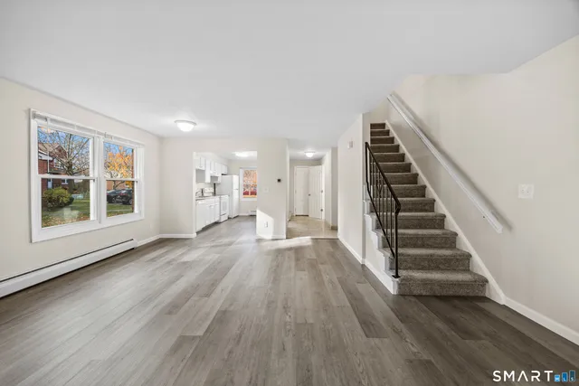 a view of wooden floor and windows in a room