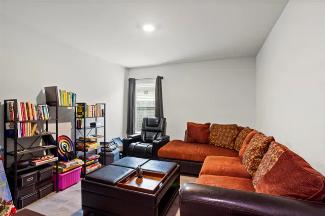 a bedroom with a bed a table and chair