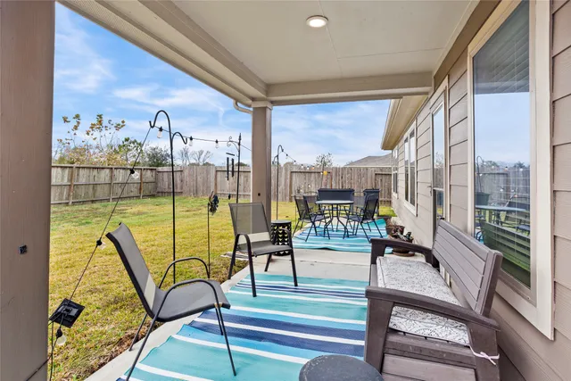 a front view of a house with a yard table and chairs
