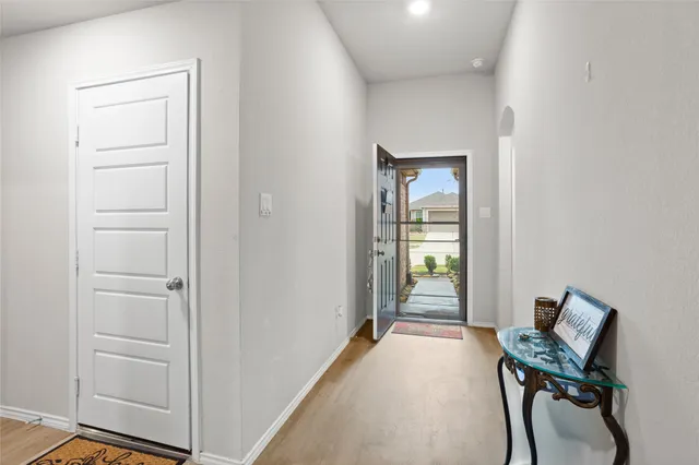 a living room with furniture a desk and chair with wooden floor
